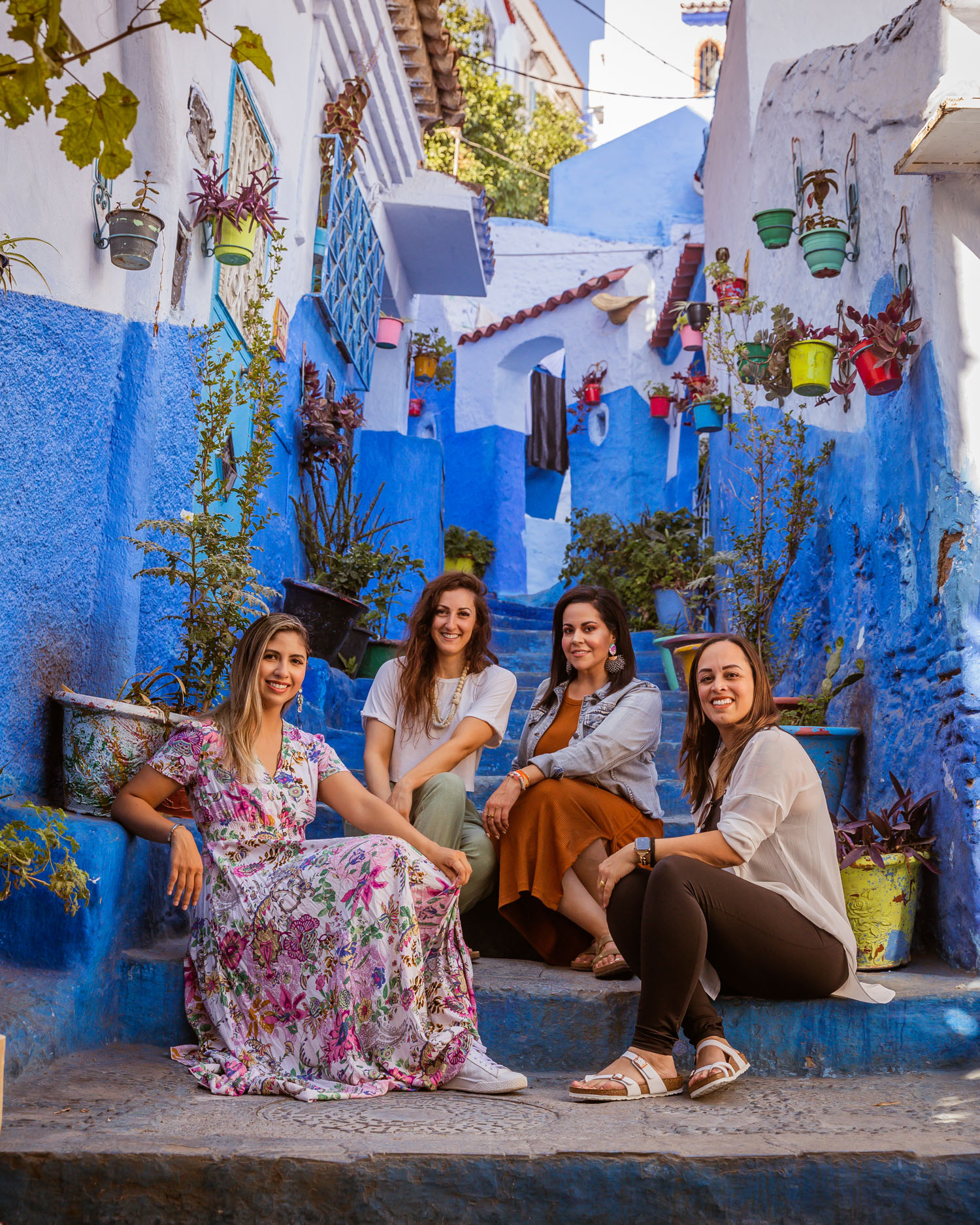 Chefchaouen Blue City Morocco; group of women sitting on blue stairs