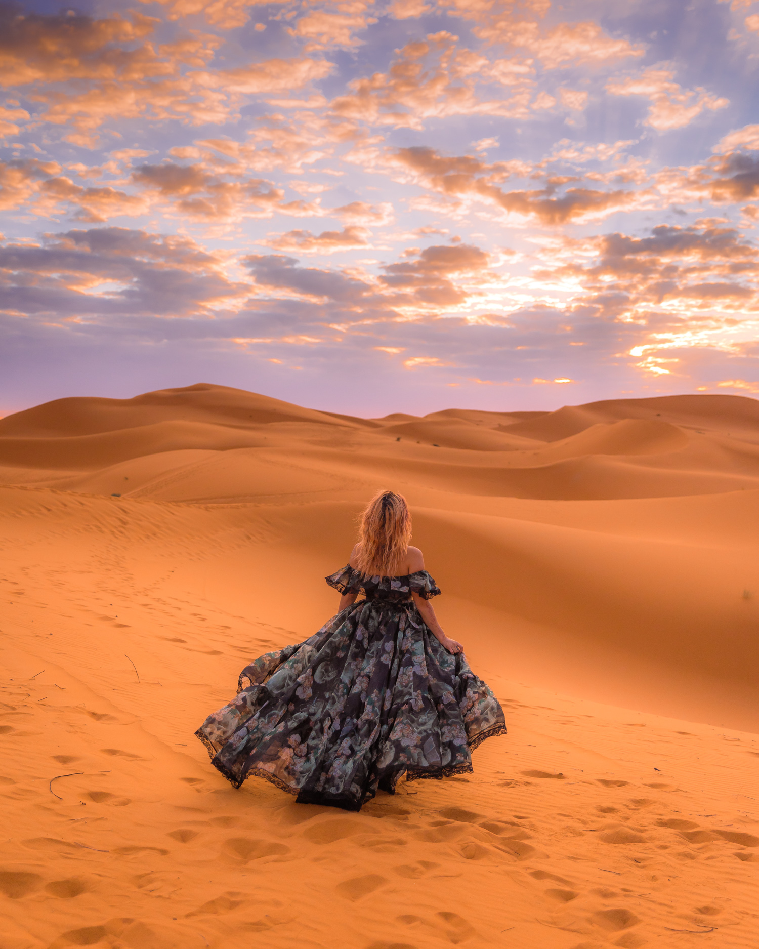 Sunrise in the Sahara, Morocco; woman in a Selkie dress
