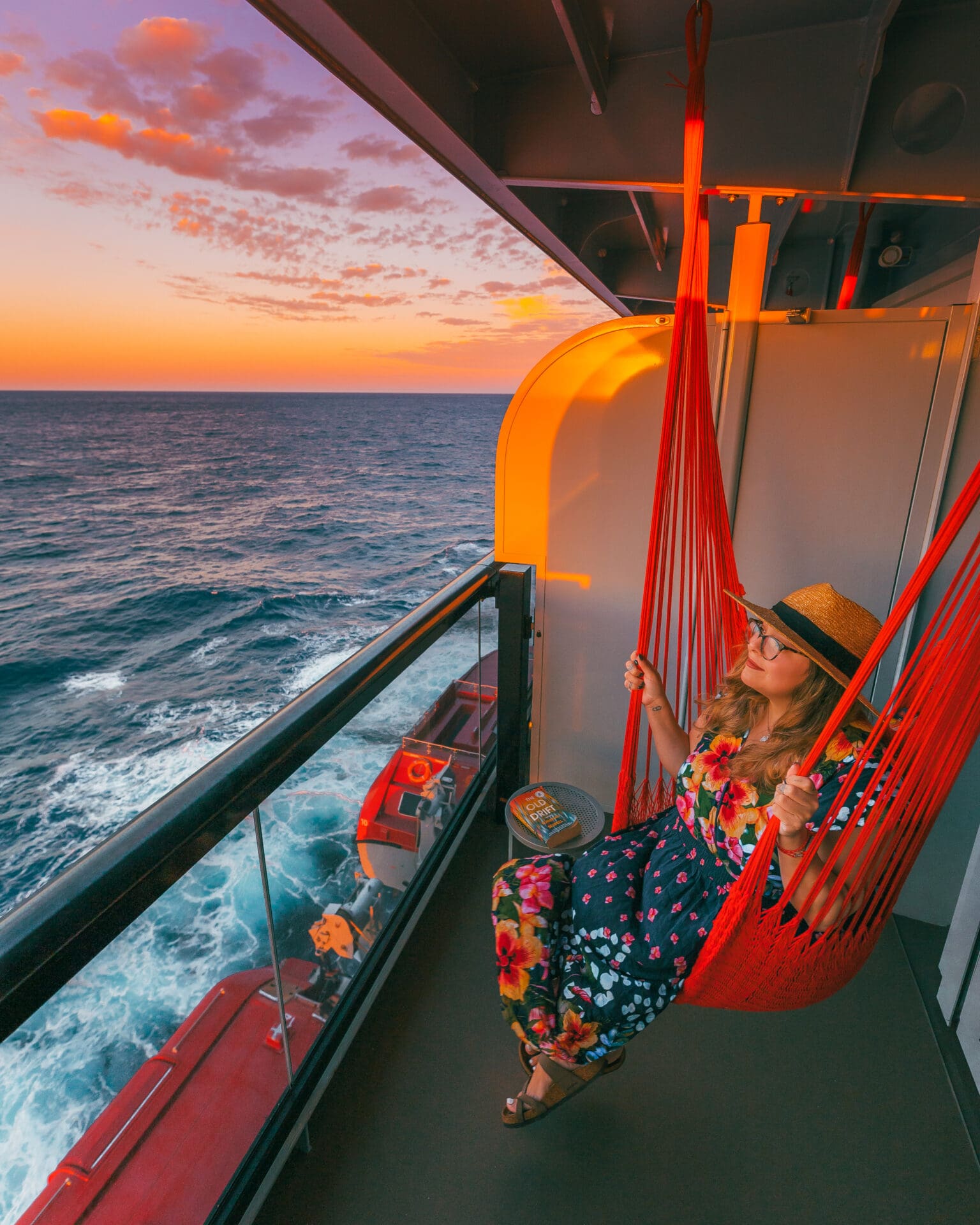 Sitting in a hammock at sunset in our balcony cabin onboard Virgin Voyages